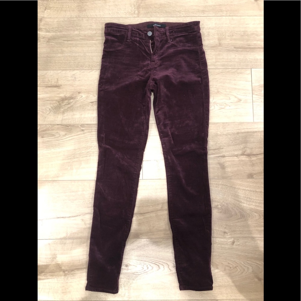 Woman’s maroon velvet skinny jeans.